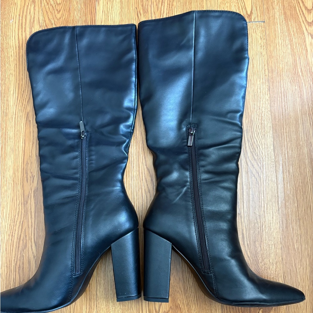 Back faux leather knee high boots.